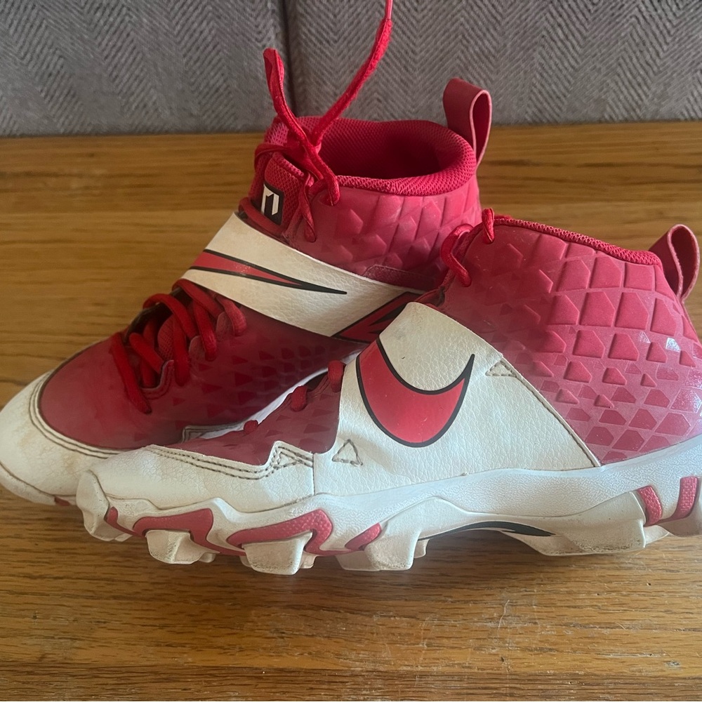 Nike Kids red and white baseball cleats.